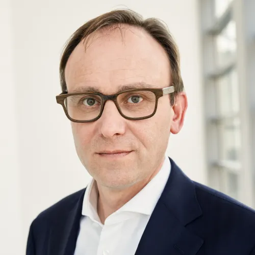 a man in a suit and glasses